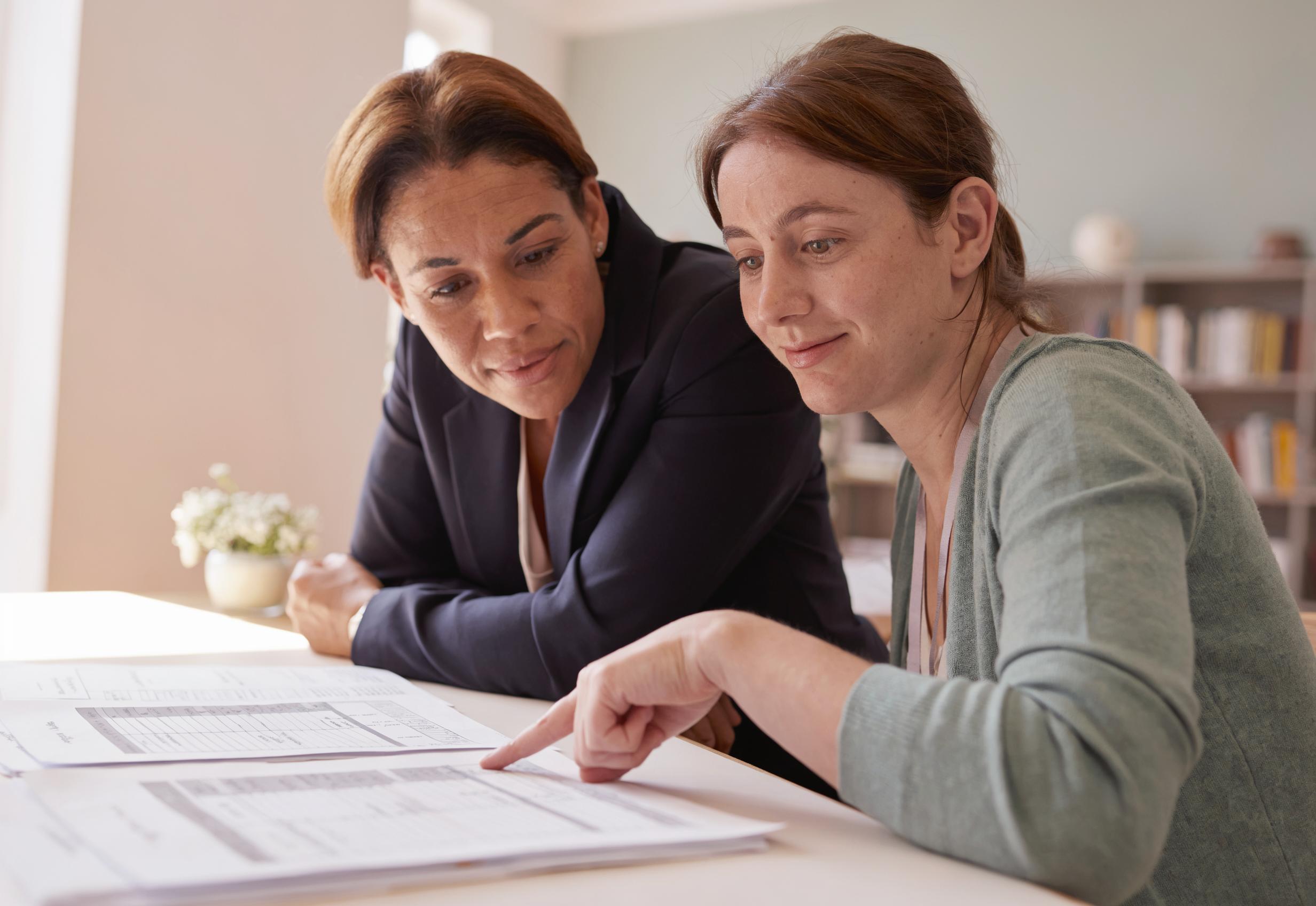 A parent and a Florida-certified teacher reviewing a student's records together